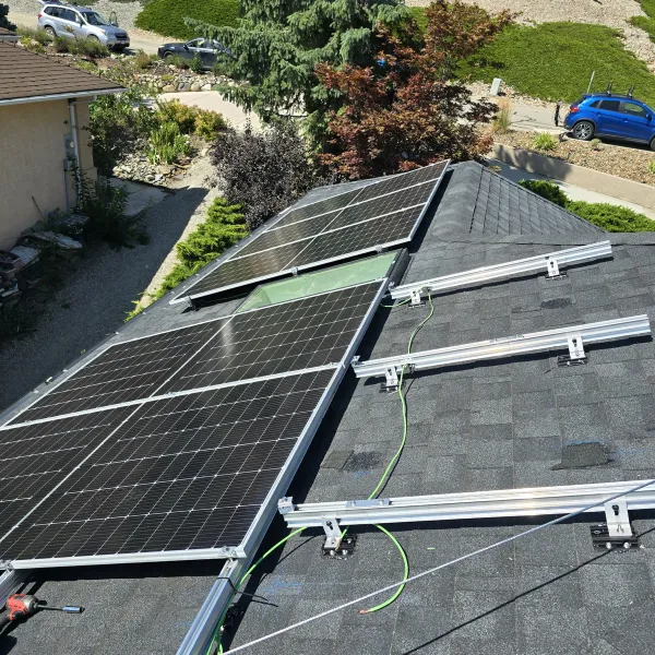New panels going onto aluminium rails on a shingle roof