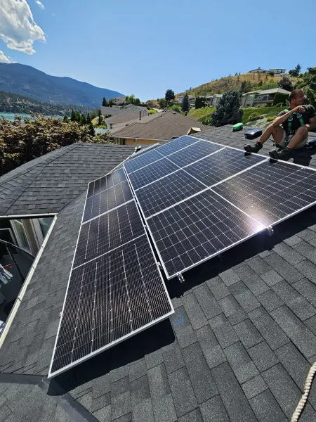 Finished rows of black panels on a shingle roof